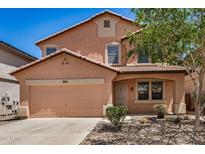 Charming two-story home featuring a two-car garage and low-maintenance desert landscaping at 18475 N Madison Rd, Maricopa, AZ 85139