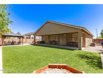 Expansive backyard featuring an artificial lawn, covered patio, gazebo, and hot tub hookups at 1926 S Longspur Ln, Gilbert, AZ 85295