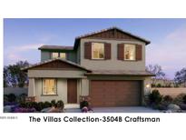 Charming two-story home with stone accents, lush landscaping, and a welcoming front porch at 22368 W Monona Ln, Surprise, AZ 85387