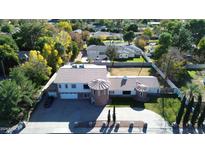 Aerial view of a landscaped property featuring unique turret design and mature trees at 333 W Bethany Home Rd, Phoenix, AZ 85013
