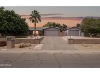 Charming single-story home with a spacious driveway and a well-manicured front yard, showcasing curb appeal at 4112 W Monte Cristo Ave, Phoenix, AZ 85053