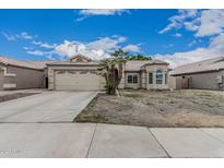 Charming single-story home with a spacious driveway and two-car garage at 705 W Country Estates Ave, Gilbert, AZ 85233