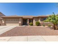Charming single-story home featuring a two-car garage and desert landscaping at 15288 W Redfield Rd, Surprise, AZ 85379