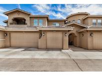 Charming townhouse showcasing a two-car garage, neutral stucco exterior, and well-maintained landscaping at 15550 S 5Th Ave # 130, Phoenix, AZ 85045