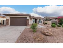 Charming single-story home with a low maintenance desert landscape and attached two car garage at 16183 W Devonshire Ave, Goodyear, AZ 85395