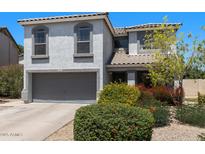 Charming two-story home featuring a grey facade, well-maintained landscaping, and a two-car garage at 1870 E Oakland St, Gilbert, AZ 85295