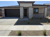 Beautiful single-story home featuring a two-car garage and a low-maintenance desert landscape at 20615 N 226Th Dr, Surprise, AZ 85387