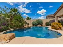 Beautiful pool surrounded by lush landscaping creating a private backyard oasis at 22322 N 77Th St, Scottsdale, AZ 85255