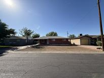 Charming single-story brick home with a well-maintained front yard on a sunny day at 2401 W Weldon Ave, Phoenix, AZ 85015