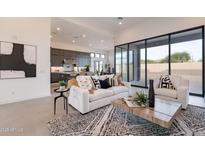 Open-concept living room featuring a stylish white sofa, modern rug, and sleek design elements at 28421 N 59Th Way, Cave Creek, AZ 85331
