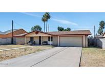 Charming single-story home featuring a two-car garage and a cozy front porch with two benches at 4333 E Desert Cactus St, Phoenix, AZ 85032