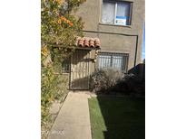 Charming home exterior featuring a secure gated entrance with decorative tile roof accent at 4628 E Wood St, Phoenix, AZ 85040