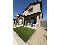 Inviting two-story home featuring a well-maintained lawn and cozy outdoor seating area at 511 S Soho Ln # 29, Chandler, AZ 85225