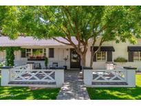 Charming white brick home with a welcoming front entrance and meticulously landscaped front yard at 6837 E Lafayette Blvd, Scottsdale, AZ 85251