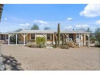 Charming single-story home features a covered porch and desert landscaping at 870 S La Paz Rd, Maricopa, AZ 85139