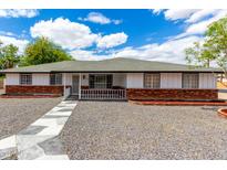 Charming single-story home with a brick facade, white siding, and a well-maintained yard at 1756 N Summer Cir, Mesa, AZ 85203
