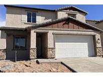 Charming two-story home with a two car garage and stone accents on the column supports at 22400 W Monona Ln, Surprise, AZ 85387