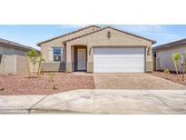 Charming single-story home with a two-car garage, low maintenance landscaping, and a well-maintained lawn at 24610 W Bowker St, Buckeye, AZ 85326