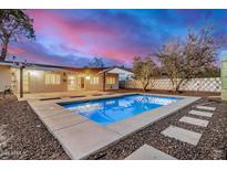 A refreshing backyard oasis featuring a sparkling pool and a peaceful outdoor area perfect for relaxation and entertainment at 317 E Belmont Ave, Phoenix, AZ 85020