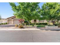 Charming single-story home with well-manicured lawn, mature trees, and a three car garage at 3648 E Fargo St, Mesa, AZ 85205
