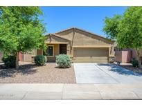 Charming single-story home featuring a two-car garage, neutral exterior, and low maintenance landscaping at 38086 W Isabella Ln, Maricopa, AZ 85138