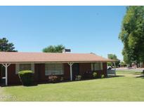 Charming single-story home with a well-maintained lawn and a classic brick facade at 3942 N 38Th St, Phoenix, AZ 85018