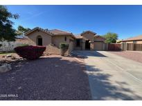 Charming single-story home with a well-maintained yard and a spacious driveway at 4130 E Megan St, Gilbert, AZ 85295