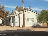 Charming single-story house with stucco exterior and mature trees in a quiet neighborhood at 42 W Thomas Ln, Tempe, AZ 85281