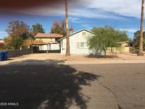 The exterior of the home includes a covered parking area and low-maintenance landscaping at 42 W Thomas Ln, Tempe, AZ 85281
