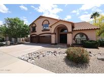 Charming two-story home featuring a terracotta roof and three-car garage at 4441 E Sunnyside Ln, Phoenix, AZ 85032