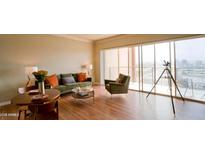 Bright living room with sleek hardwood floors, comfortable seating, and expansive city views at 4750 N Central Ave # D15, Phoenix, AZ 85012