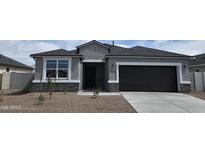 Charming single-story home with a gray exterior, black garage door and front door, and low-maintenance landscaping at 5704 E Smeaton Pl, San Tan Valley, AZ 85140