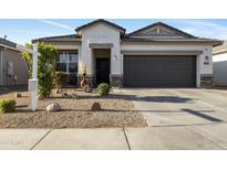 Charming single-story home featuring a low-maintenance yard and a two-car garage at 7812 W Payson Rd, Phoenix, AZ 85043