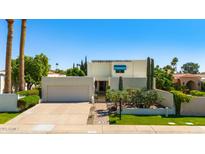 Beautiful contemporary home with desert landscaping, attached garage, and manicured lawn at 8637 E Via De La Escuela --, Scottsdale, AZ 85258