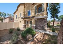 Two-story home with a desert-landscaped yard and a combination of stone and stucco exterior finishes at 9233 E Neville Ave # 1125, Mesa, AZ 85209