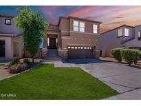 Charming two-story home featuring a well-maintained lawn, mature tree, and inviting front porch at 1187 E Frances Ln, Gilbert, AZ 85295