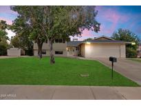 Charming two-story home with a well-manicured front yard, mature trees, and an attached two-car garage at 13411 N 50Th St, Scottsdale, AZ 85254