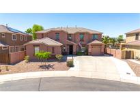 Charming two-story home with a well-maintained front yard and extended driveway on a cul-de-sac street at 15725 W Yucatan Dr, Surprise, AZ 85379