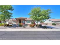 Charming single-story home featuring a well-manicured front yard, stone accents, and a vibrant desert landscape at 226 W Crimson Sky Ct, Casa Grande, AZ 85122