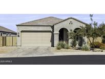 Charming single-story home with a two-car garage, arched entryway, and desert landscaping at 2354 E Lieber Pl, Phoenix, AZ 85024