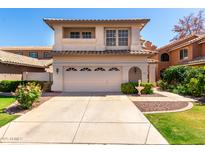 Charming two-story home showcasing a well-manicured lawn, tiled roof, and attached two-car garage at 3165 W Golden Ln, Chandler, AZ 85226