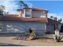 Charming two-story home featuring desert landscaping, a red tile roof, and an attached two-car garage at 4636 E Carmen St, Phoenix, AZ 85044