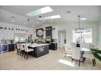 Bright, open kitchen with a large island, modern appliances, and skylights for natural lighting at 5430 E Shea Blvd, Scottsdale, AZ 85254