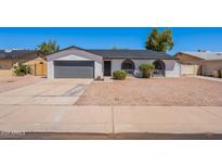 Charming single-story home featuring a well-maintained front yard and a two-car garage at 5534 W Calavar Rd, Glendale, AZ 85306