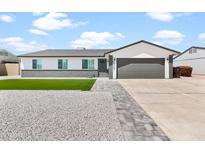 Charming single-story home with a well-maintained front yard and modern gray accents at 6908 W Sierra St, Peoria, AZ 85345