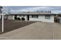 Charming single-story home with well-maintained landscaping and a spacious front yard at 845 N Los Alamos Dr, Goodyear, AZ 85338