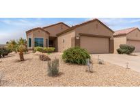 Charming single-story home featuring desert landscaping, a two-car garage, and a cozy, inviting facade at 16205 W Mountain Pass Dr, Surprise, AZ 85374