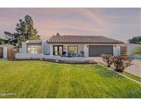 Charming single-story home with a well-manicured lawn and beautiful tiled roof at 1747 W Echo Ln, Phoenix, AZ 85021