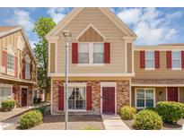 Charming multi-level home featuring brick accents, red shutters and a welcoming walkway leading to the front door at 18811 N 34Th Ave # 6, Phoenix, AZ 85027