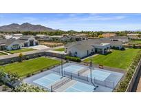Beautiful aerial shot showcasing a home with a large sports court and manicured landscaping at 18826 E Augusta Ave, Queen Creek, AZ 85142